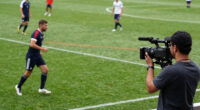 Cameraman catches the person using laser light on players in a football match